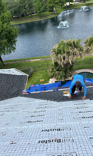 Roofer working on lakefront property roof
