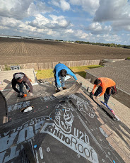 Team of roofers working together on underlayment