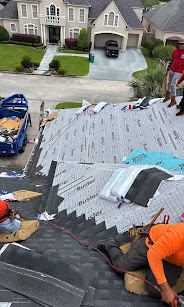 Roof Repair Services crew installing synthetic underlayment